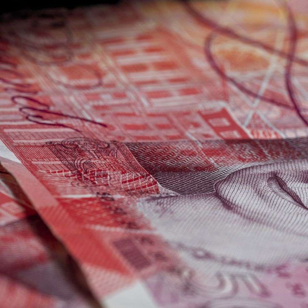 British pound notes representing unpaid debts and debt recovery in London