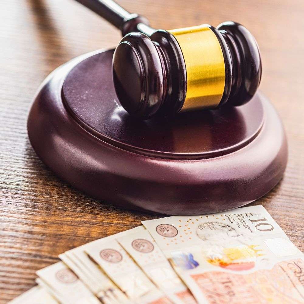 Gavel and cash representing legal debt recovery and enforcement services